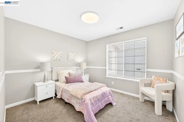 a spacious bedroom with a bed and a table