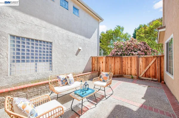 a backyard of a house with table and chairs
