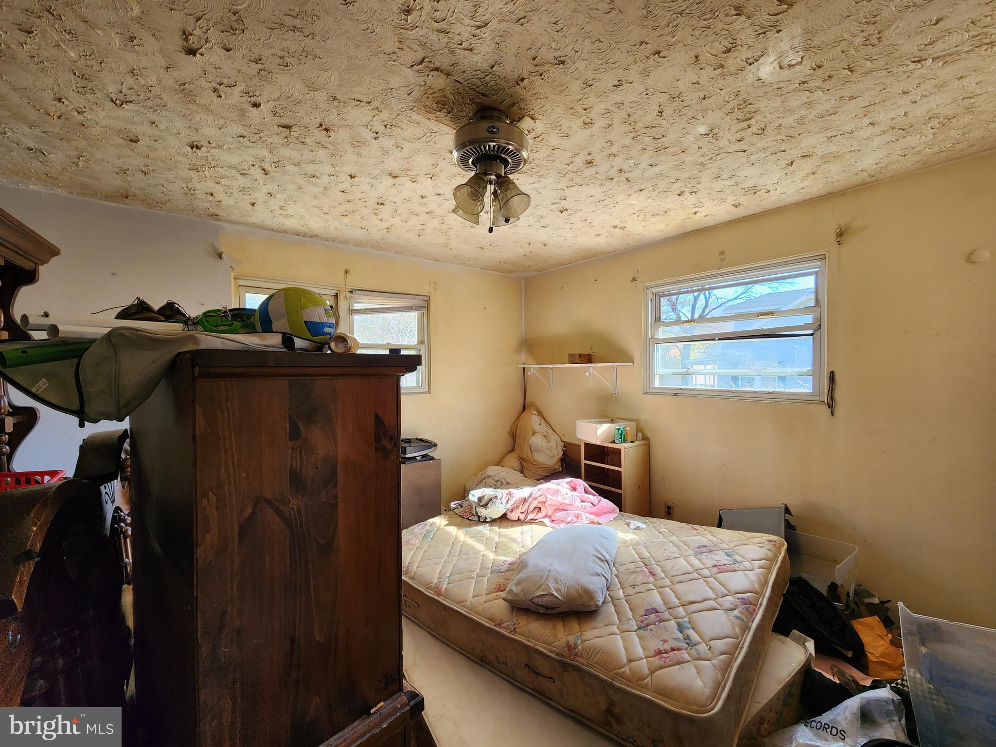 6701 Bessemer Avenue Baltimore, MD 21222 - Photo 11 of 16 a bedroom with a bed and cabinets