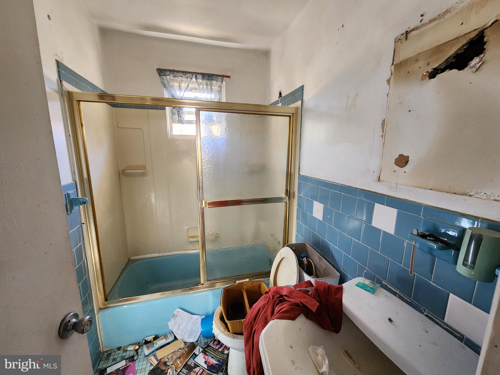 6701 Bessemer Avenue Baltimore, MD 21222 - Photo 12 of 16 a bathroom with a tub and shower