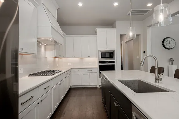 a kitchen with a sink stove and refrigerator