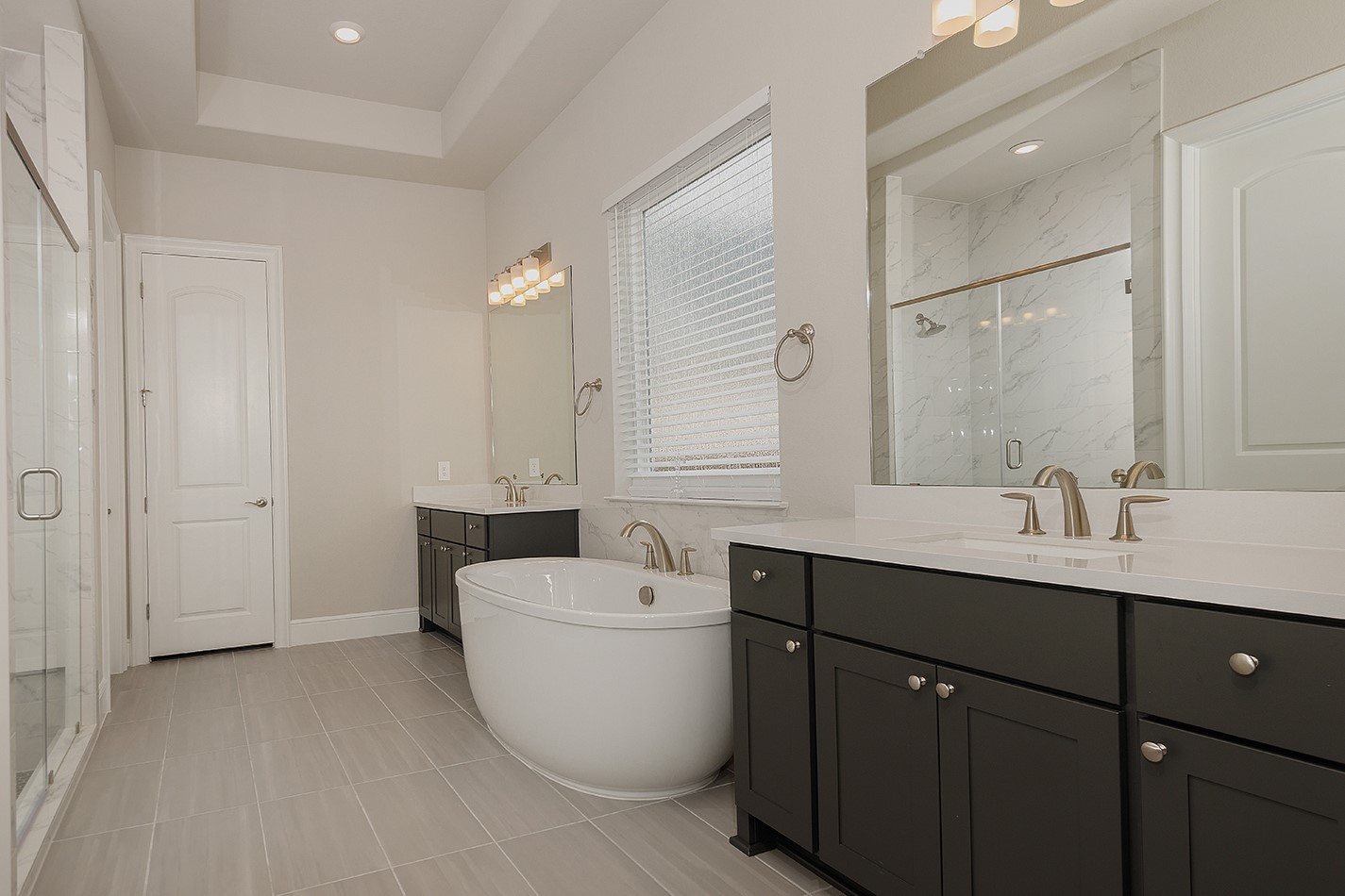 5361 Cherry Spring Drive Spring, TX 77386 - Photo 18 of 35 a bathroom with a double vanity sink a mirror and a bathtub