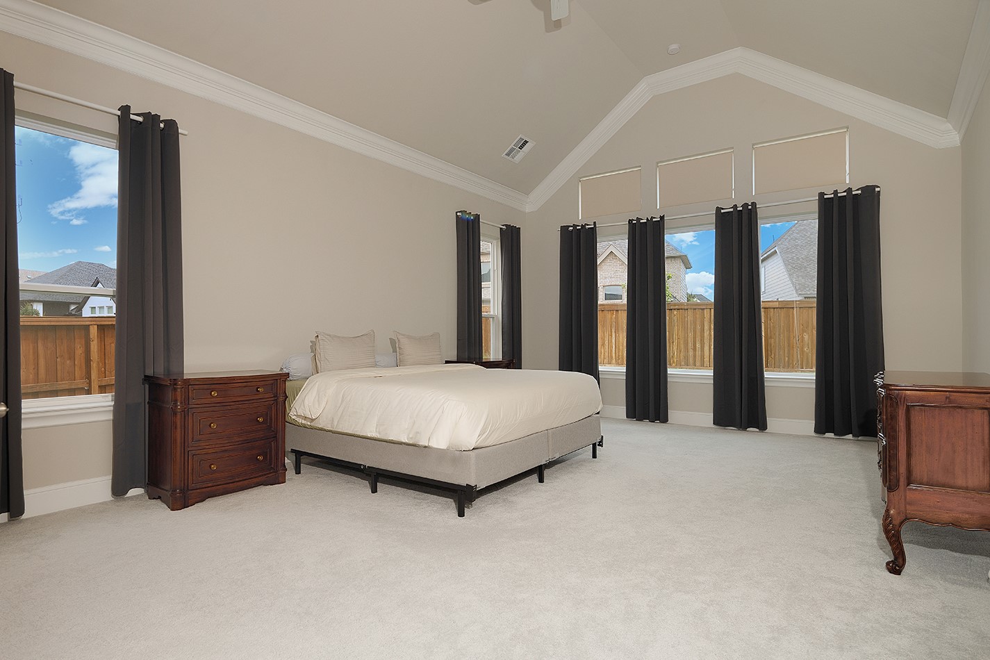 5361 Cherry Spring Drive Spring, TX 77386 - Photo 21 of 35 a spacious bedroom with a large bed and a chandelier