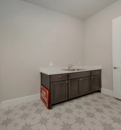 an empty room with closet and a chandelier fan