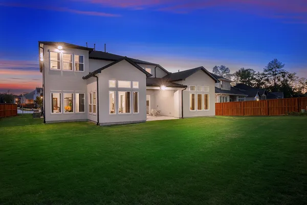 a view of backyard with wooden fence