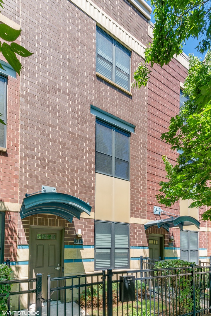 434 West Elm Street Chicago, IL 60610 - Photo 1 of 18 a front view of a house with glass top table and chairs
