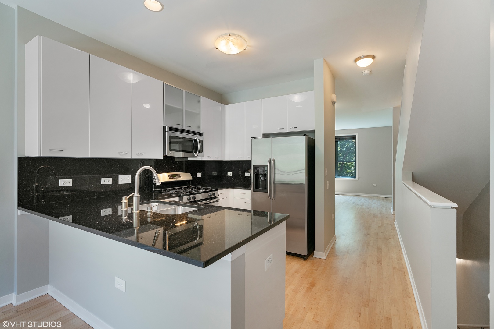 434 West Elm Street Chicago, IL 60610 - Photo 2 of 18 a kitchen with stainless steel appliances granite countertop a refrigerator a stove a sink a microwave and cabinets