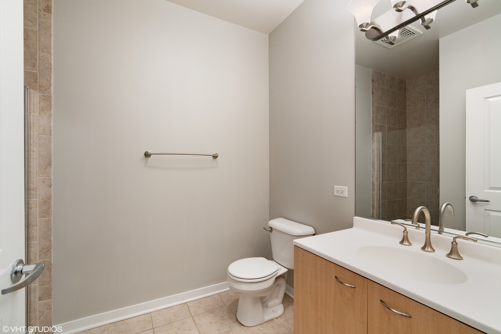434 West Elm Street Chicago, IL 60610 - Photo 11 of 18 a bathroom with a sink a toilet and a mirror