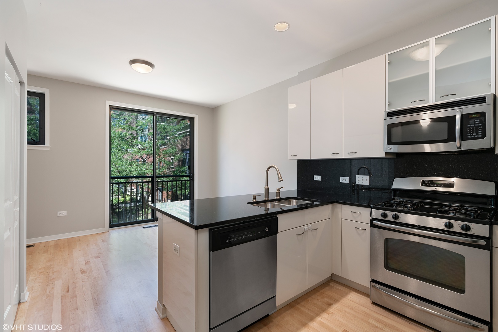 434 West Elm Street Chicago, IL 60610 - Photo 3 of 18 a kitchen with stainless steel appliances granite countertop a stove a microwave and sink