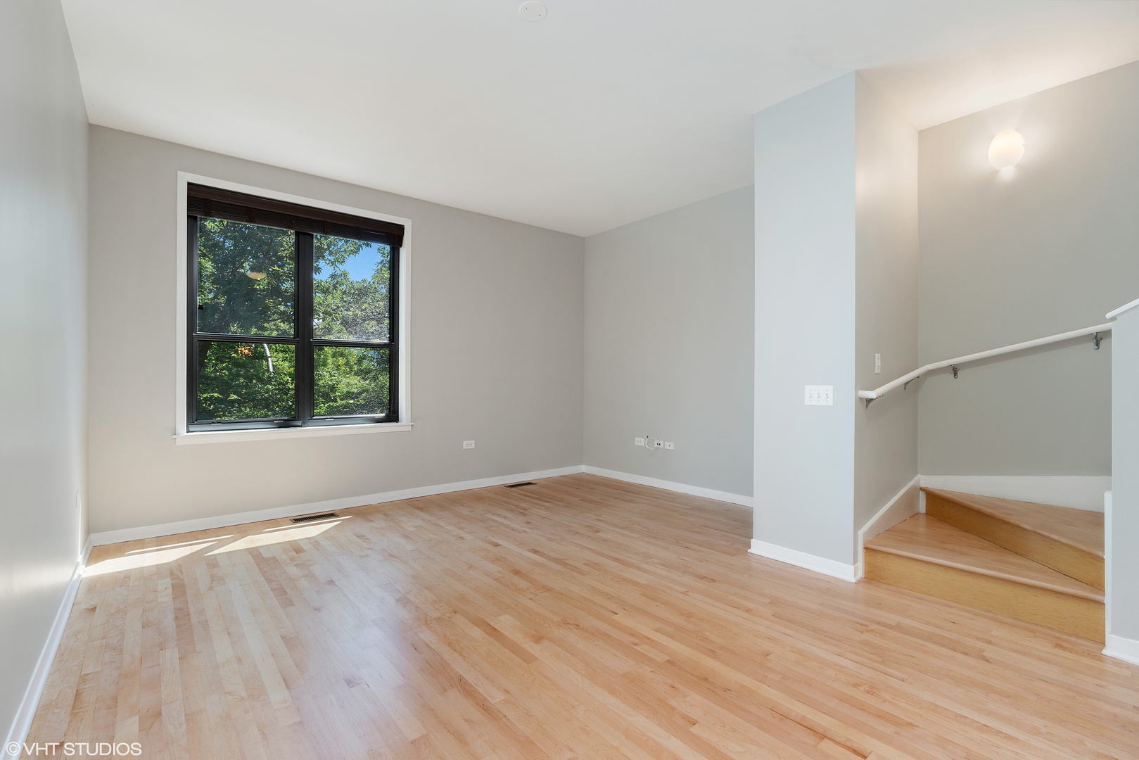 434 West Elm Street Chicago, IL 60610 - Photo 4 of 18 a view of an empty room with wooden floor and a window