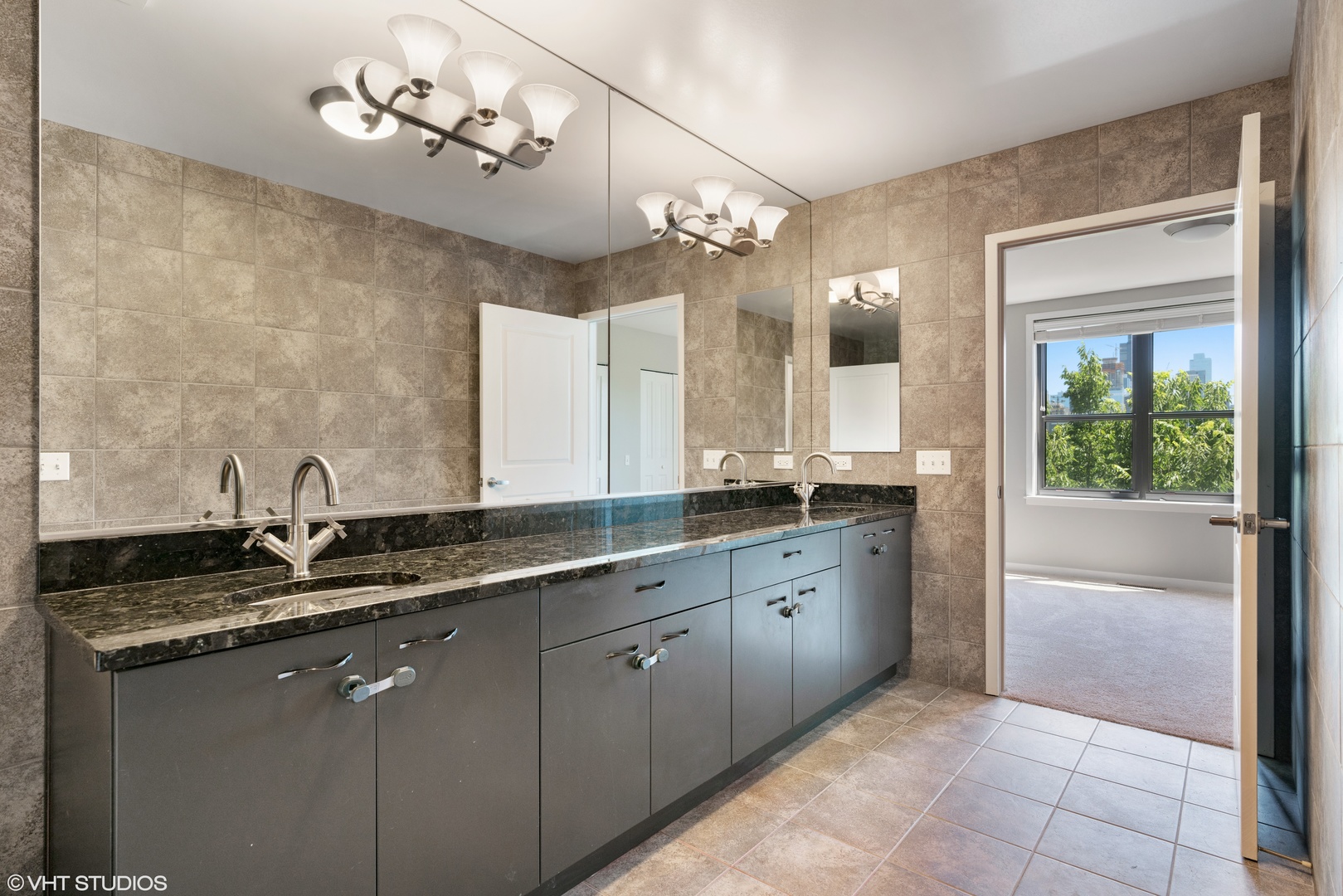 434 West Elm Street Chicago, IL 60610 - Photo 7 of 18 a bathroom with a granite countertop sink a large mirror and a shower