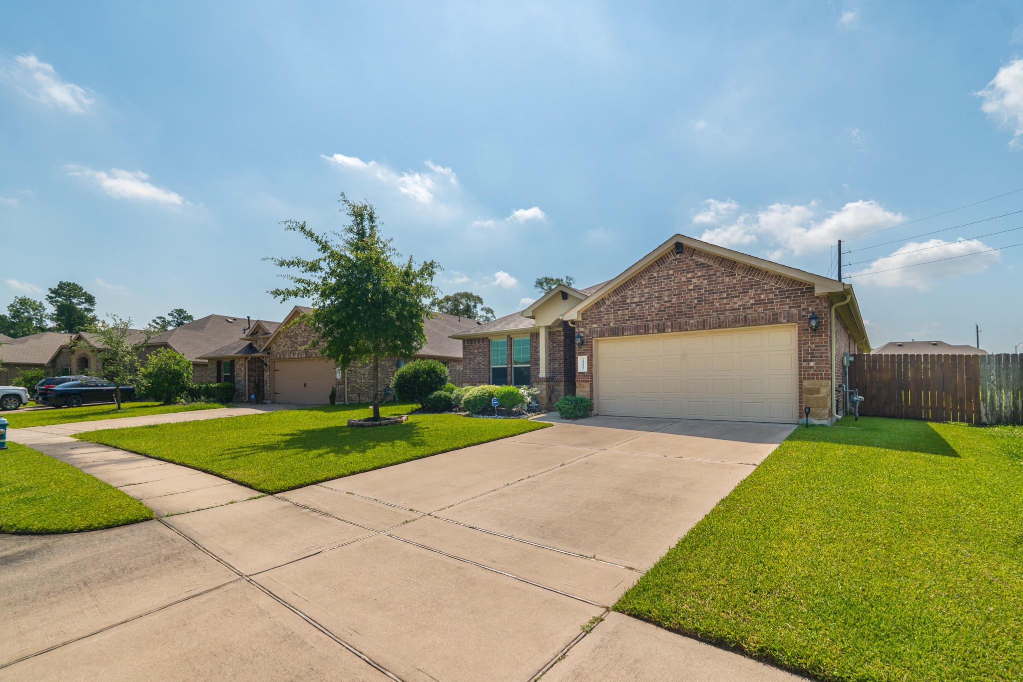 24322 North Newcastle Bay Trail Spring, TX 77389 - Photo 6 of 50 a front view of a house with a yard and garage