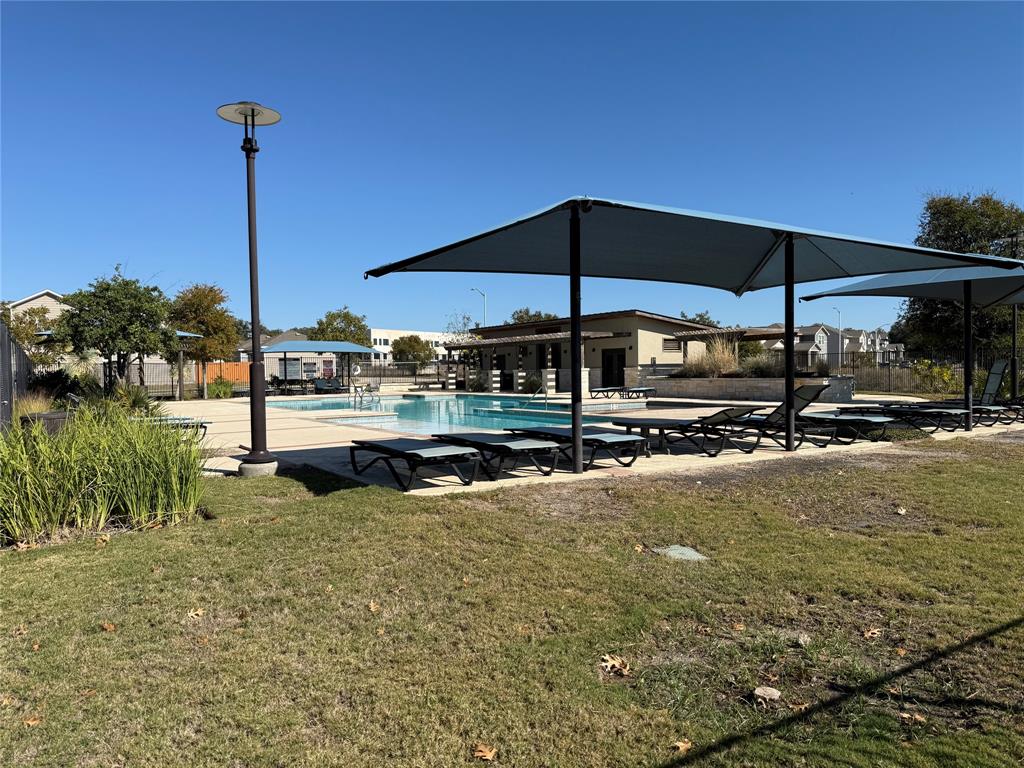 1809 Turtle Bay Loop Leander, TX 78641 - Photo 27 of 30 A refreshing community pool area beckons with ample lounging space under shaded awnings.