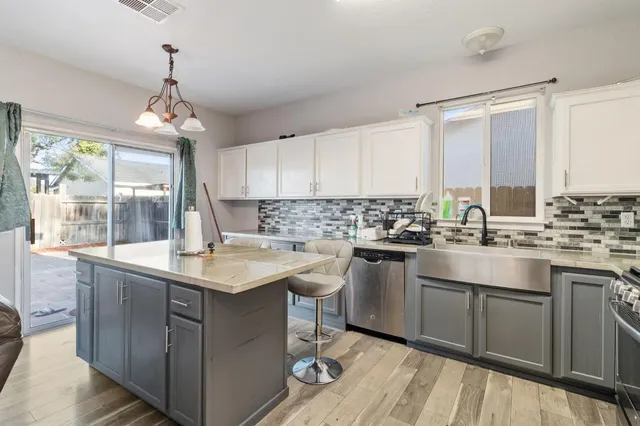 a kitchen with a sink window and cabinets
