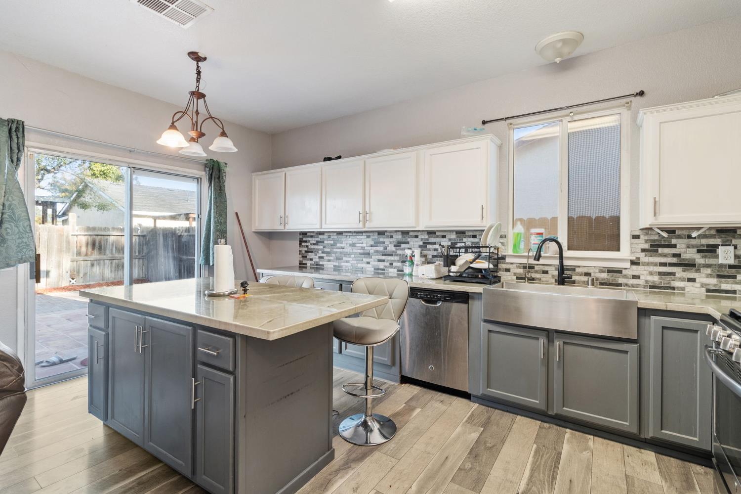 701 Palmer Place Atwater, CA 95301 - Photo 13 of 31 a kitchen with a sink window and cabinets
