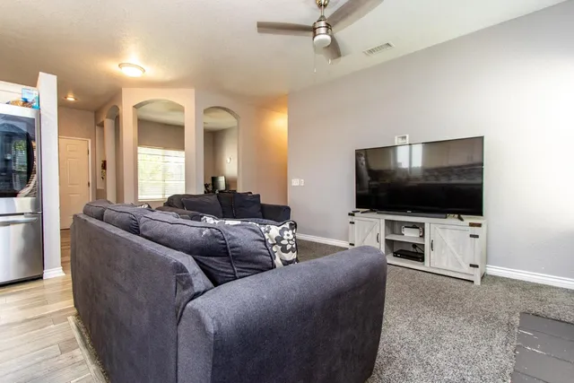 a view of a kitchen with white cabinets and wooden floor