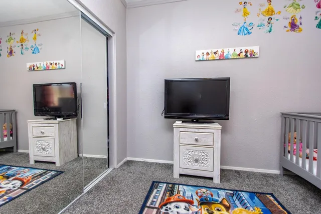 a view of backyard with small cabin and wooden fence