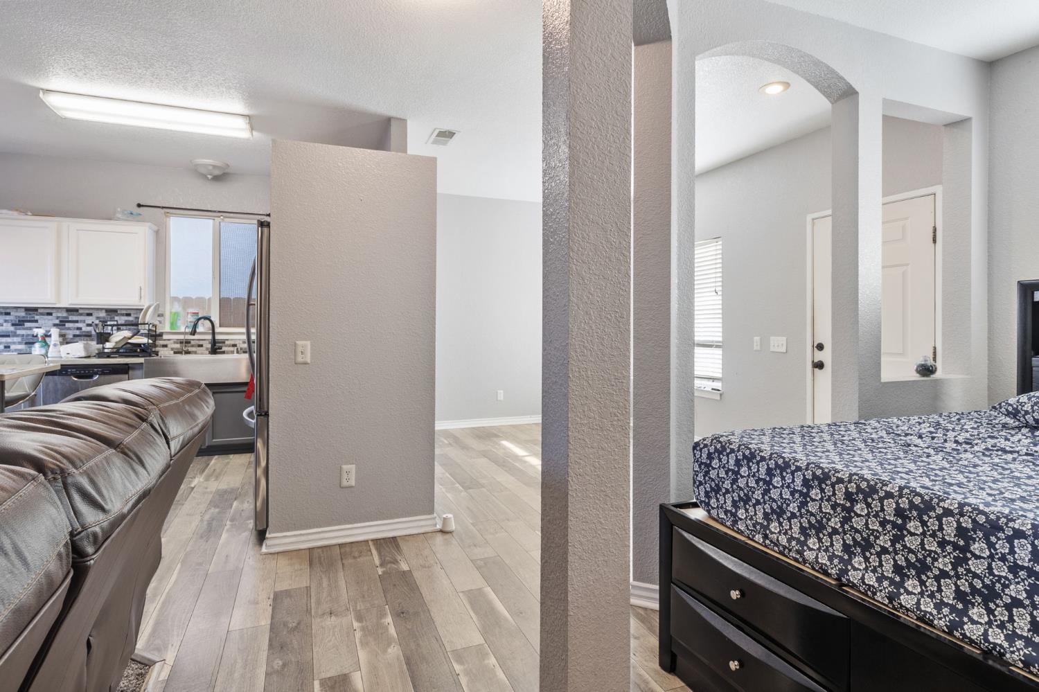 701 Palmer Place Atwater, CA 95301 - Photo 27 of 31 a bedroom with a bed and a chandelier