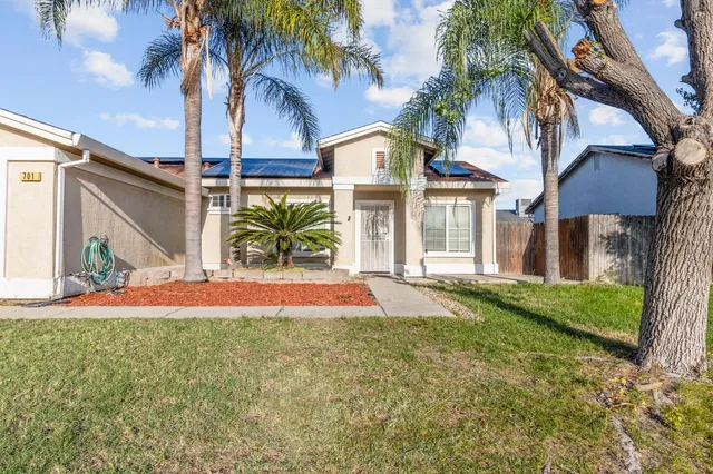 a front view of house with yard and green space