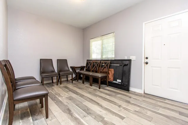a living room with flat screen tv and a fireplace
