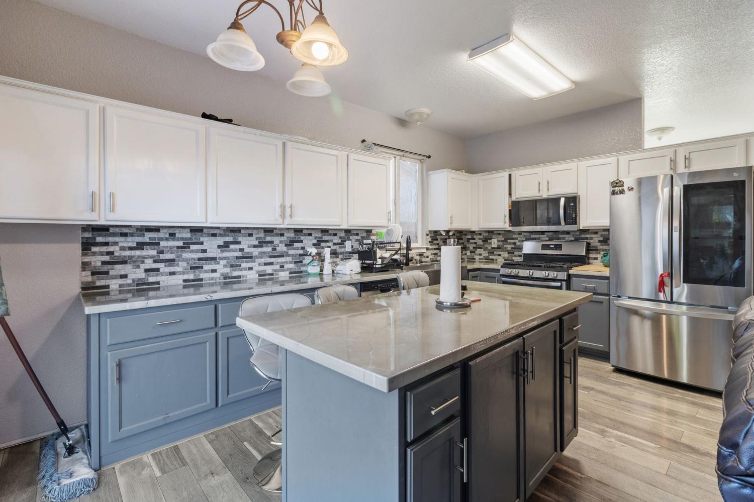 701 Palmer Place Atwater, CA 95301 - Photo 8 of 31 a kitchen with a sink stove and refrigerator