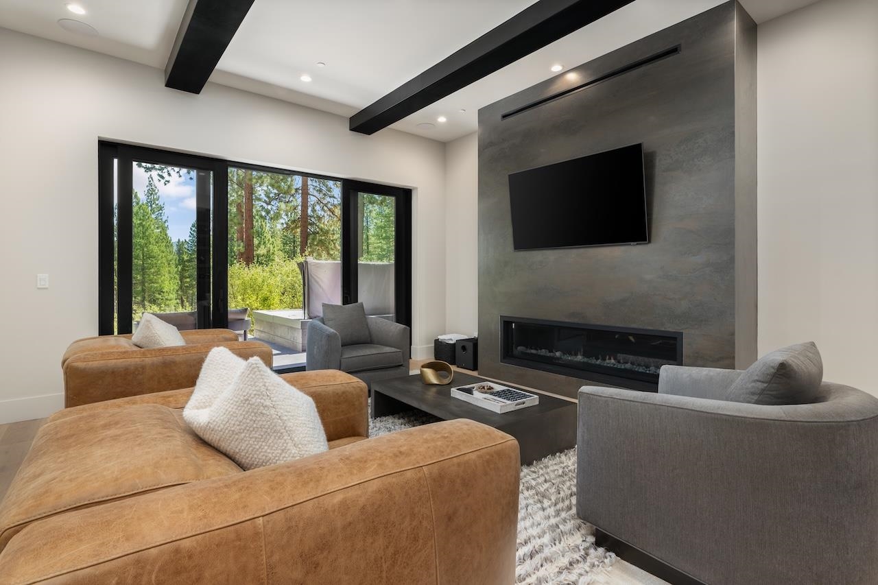 7745 Lahontan Drive Truckee, CA 96161 - Photo 14 of 28 a living room with furniture a flat screen tv and a fireplace