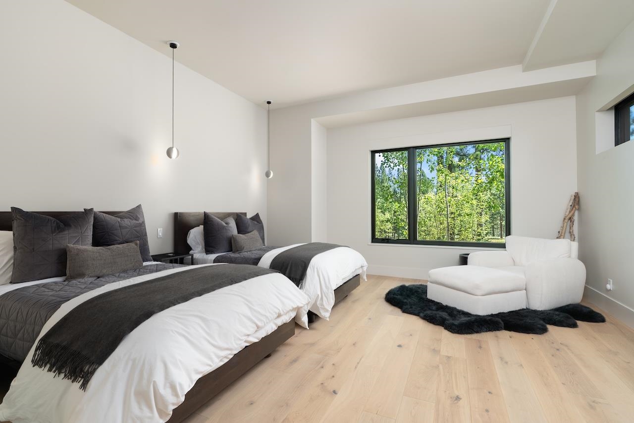 7745 Lahontan Drive Truckee, CA 96161 - Photo 17 of 28 a bedroom with two beds and a large window