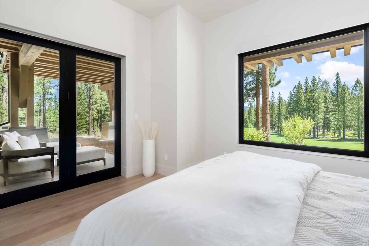 7745 Lahontan Drive Truckee, CA 96161 - Photo 21 of 28 a bedroom with a large window and a bed