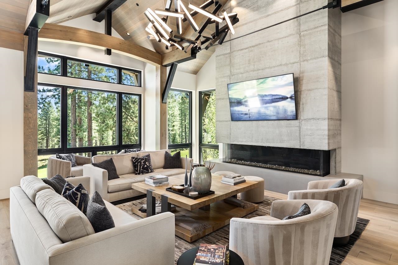 7745 Lahontan Drive Truckee, CA 96161 - Photo 4 of 28 a living room with furniture a fireplace and a floor to ceiling window