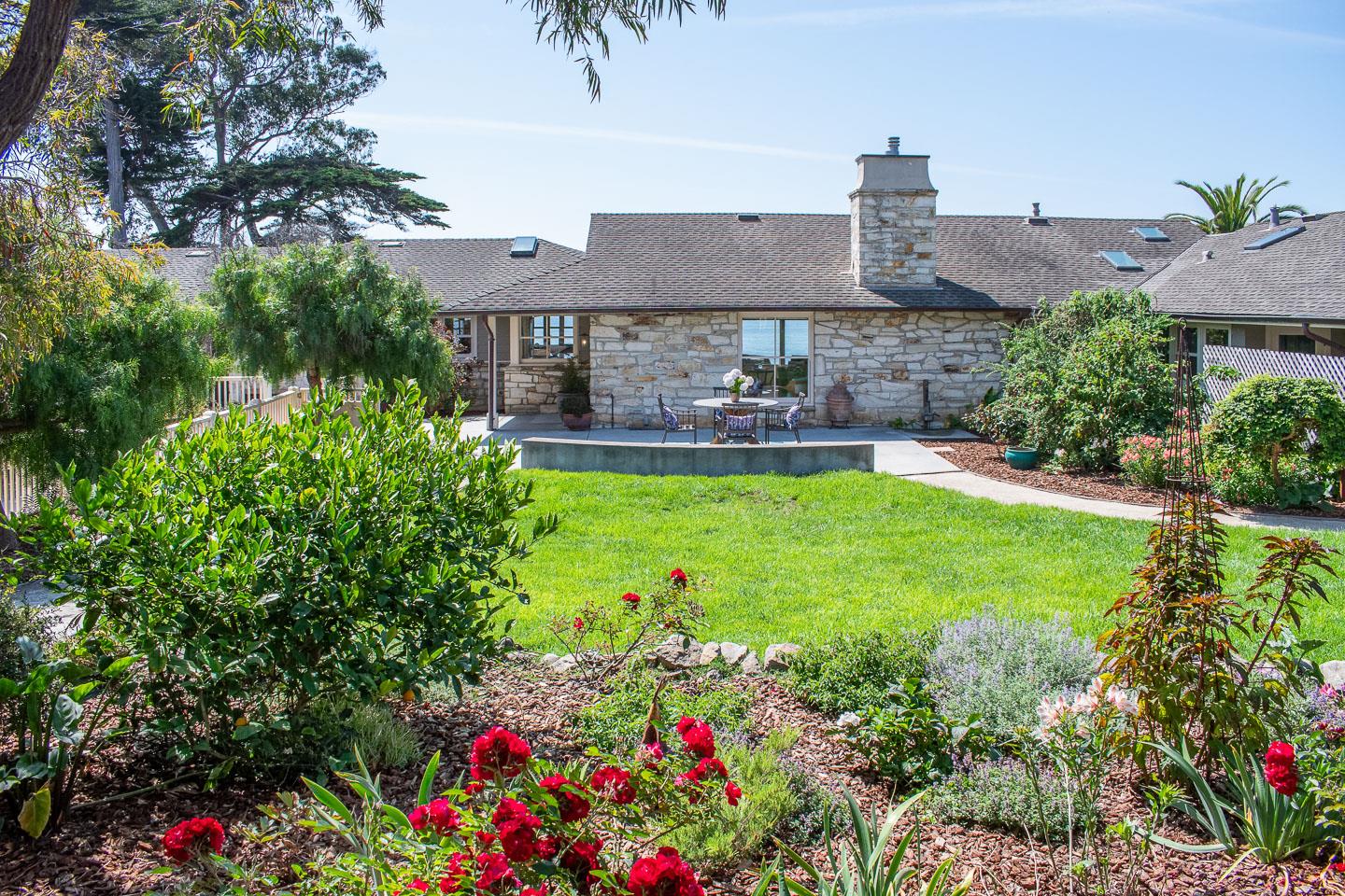 a view of a house with a big yard and potted plants