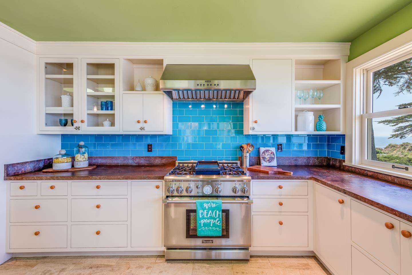 28 Cresta Way La Selva Beach, CA 95076 - Photo 18 of 39 a kitchen with granite countertop a stove a sink and wooden cabinets