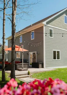 a front view of a house with a yard and potted plants