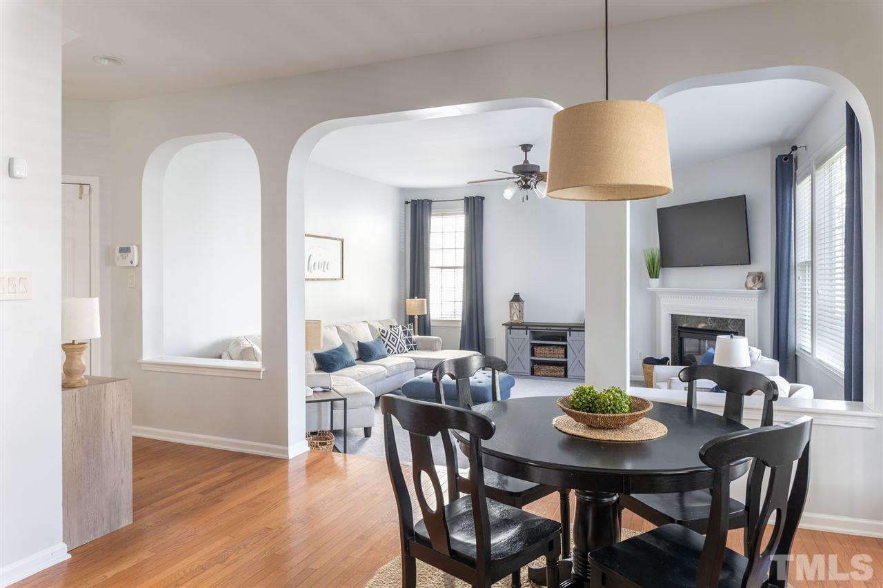 8600 Churchdown Court Raleigh, NC 27613 - Photo 14 of 29 a view of a dining room with furniture window and wooden floor