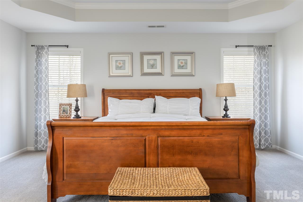 8600 Churchdown Court Raleigh, NC 27613 - Photo 16 of 29 a bedroom with a bed and window