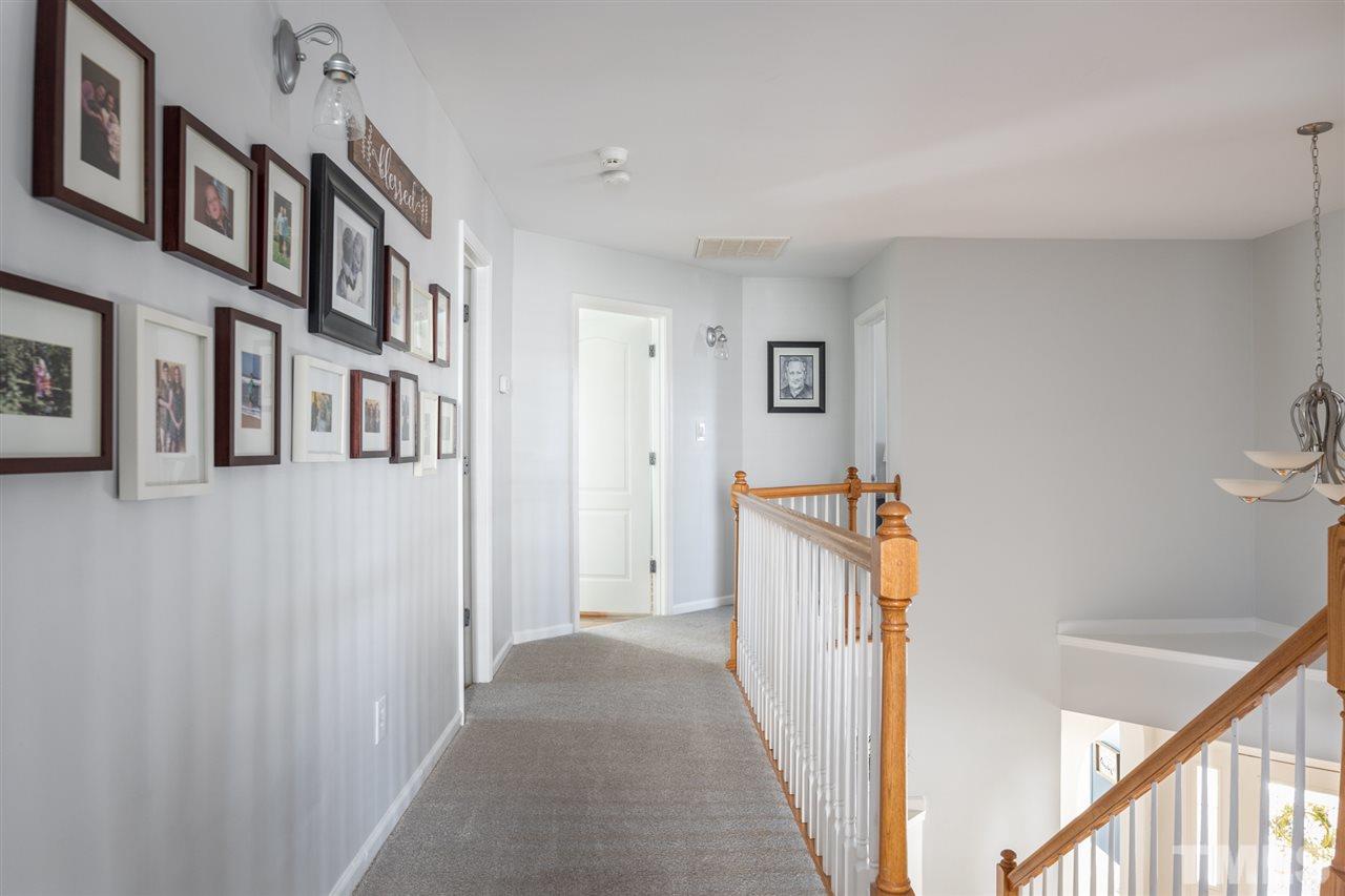 8600 Churchdown Court Raleigh, NC 27613 - Photo 20 of 29 a view of a hallway with windows