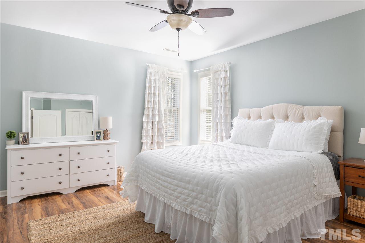 8600 Churchdown Court Raleigh, NC 27613 - Photo 21 of 29 a bedroom with a bed and window