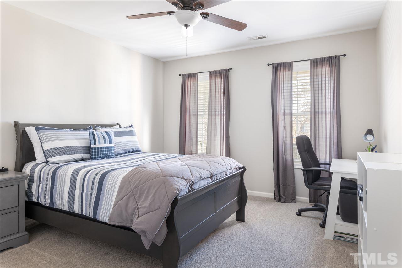 8600 Churchdown Court Raleigh, NC 27613 - Photo 22 of 29 a bed sitting in a bedroom next to a window