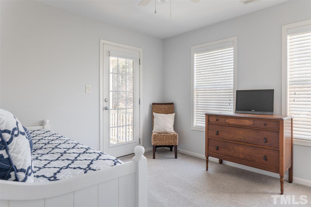 8600 Churchdown Court Raleigh, NC 27613 - Photo 23 of 29 a living room with furniture and a flat screen tv