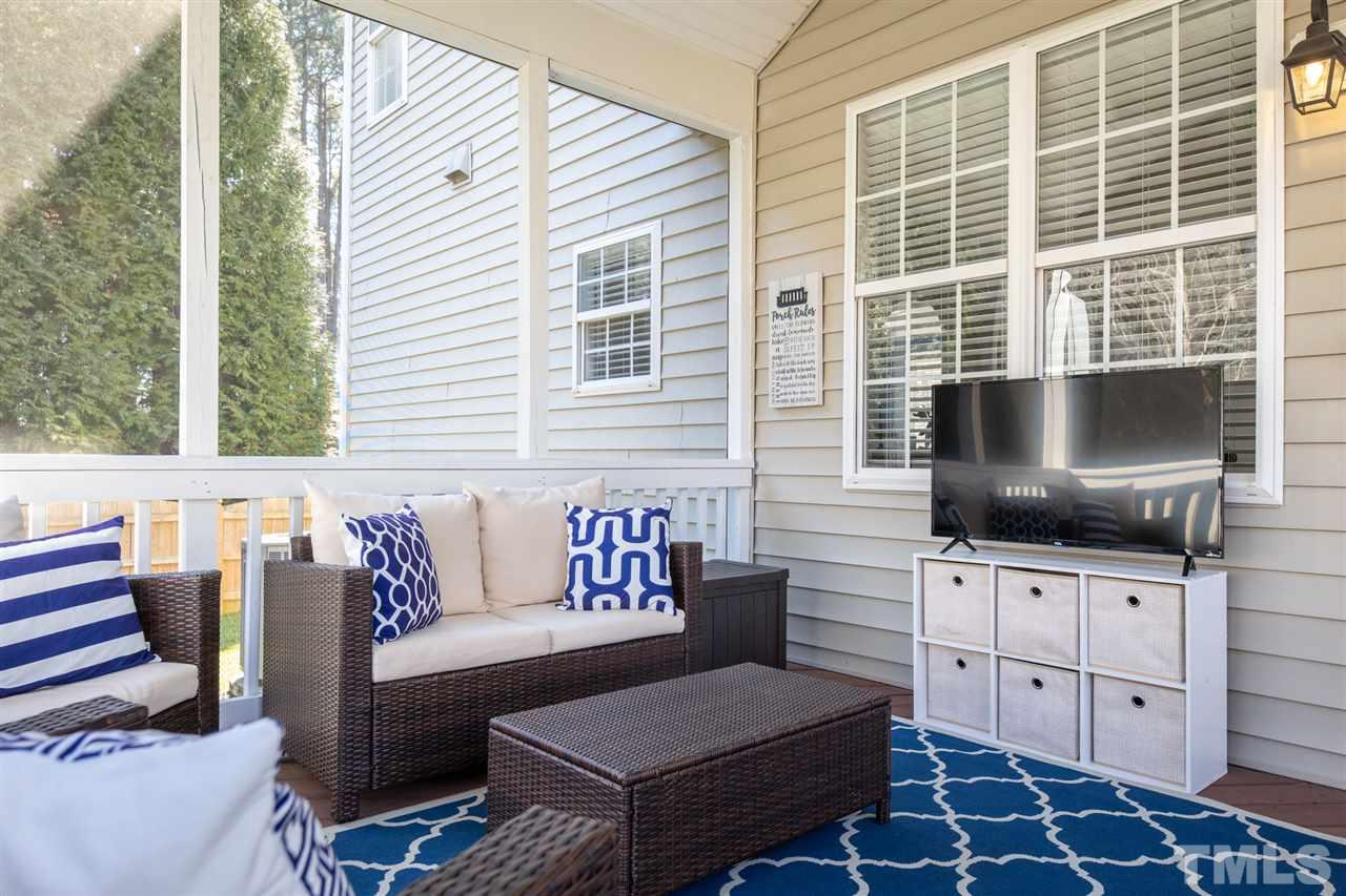 8600 Churchdown Court Raleigh, NC 27613 - Photo 28 of 29 a living room with furniture and a flat screen tv