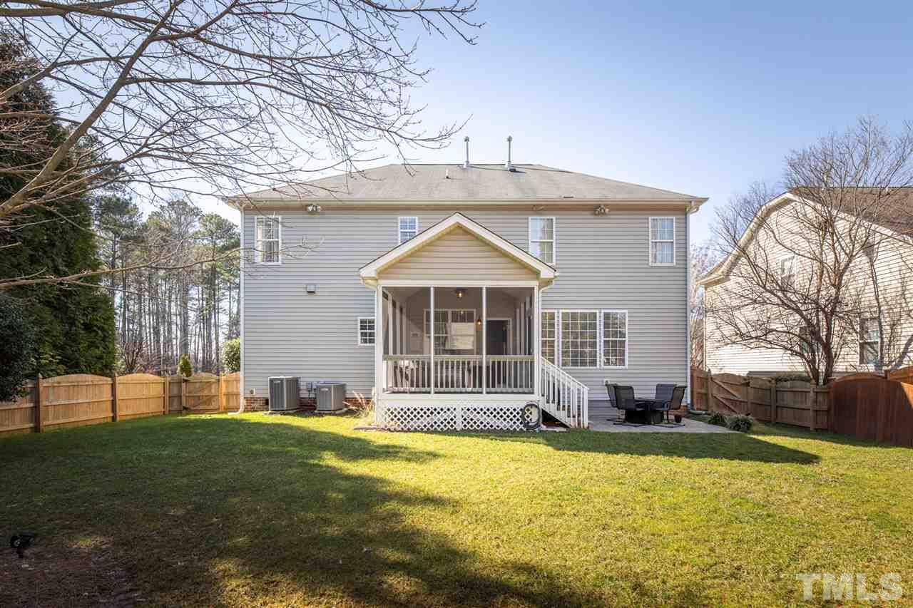 8600 Churchdown Court Raleigh, NC 27613 - Photo 29 of 29 a front view of house with yard and trees in the background