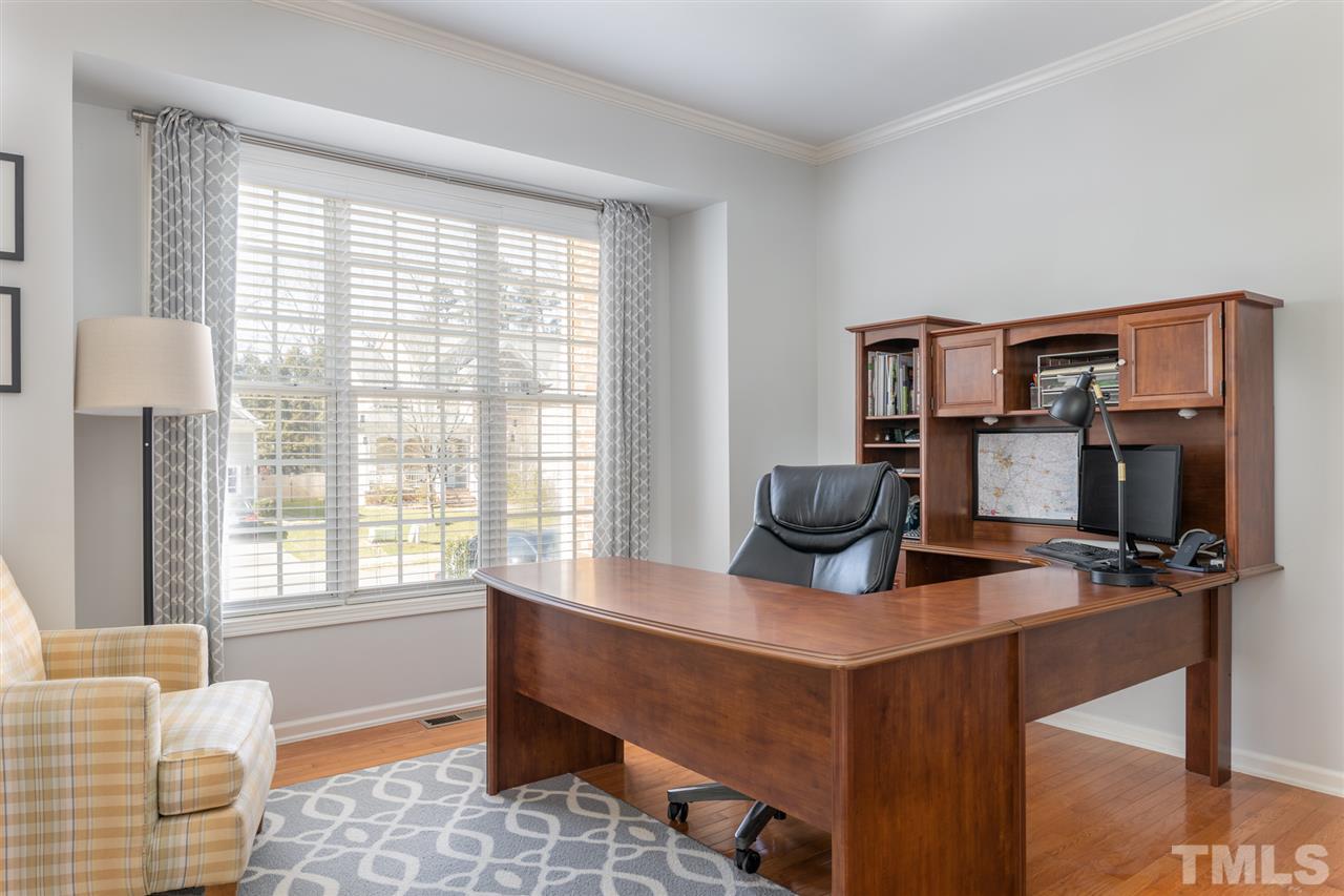 8600 Churchdown Court Raleigh, NC 27613 - Photo 5 of 29 a view of a workspace with furniture and a window