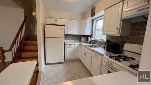 a kitchen with a refrigerator stove and sink