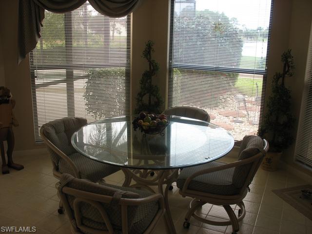 117 Muirfield Circle Naples, FL 34113 - Photo 6 of 12 a dining room with furniture and window