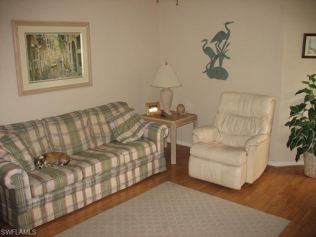 117 Muirfield Circle Naples, FL 34113 - Photo 9 of 12 a living room with furniture and a potted plant