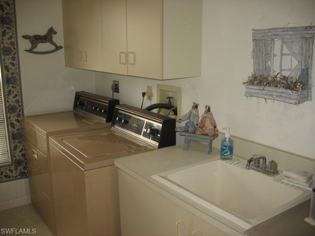 117 Muirfield Circle Naples, FL 34113 - Photo 10 of 12 a utility room with dryer and washer