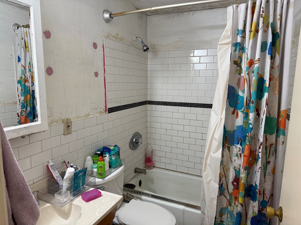 220 Swanson Road, Unit 604 Boxborough, MA 01719 - Photo 5 of 7 a bathroom with a sink toilet and shower