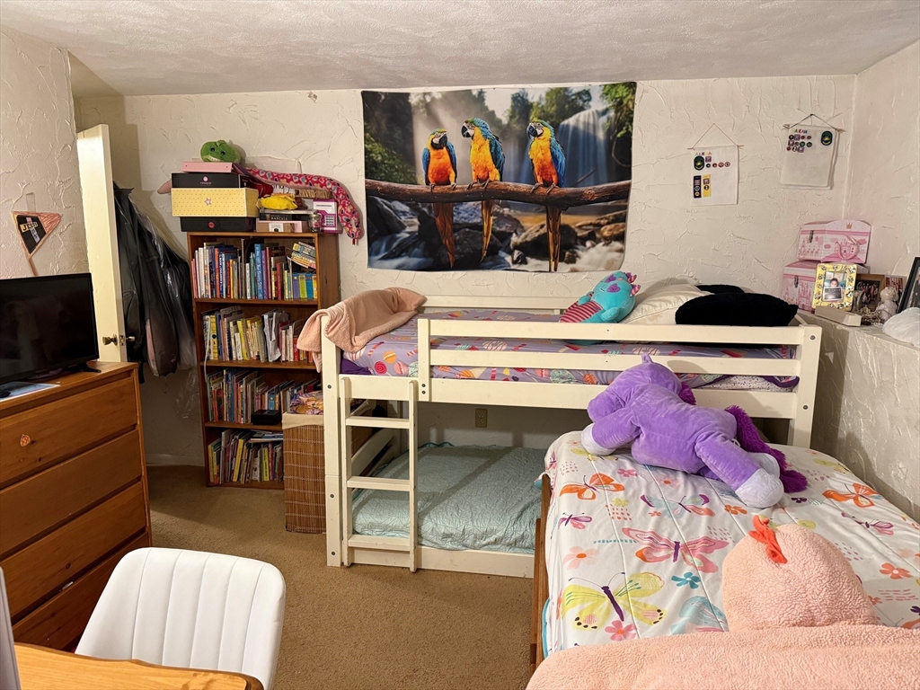 220 Swanson Road, Unit 604 Boxborough, MA 01719 - Photo 6 of 7 a bedroom with a bed and a walk in closet