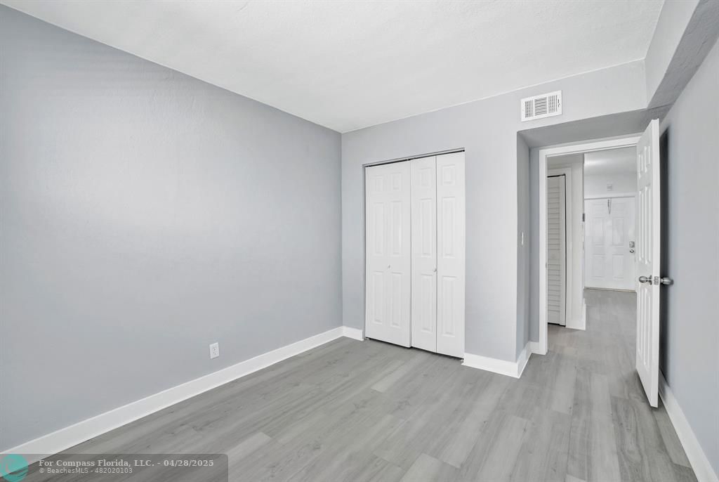 2741 Northeast 8th Avenue, Unit 15 Wilton Manors, FL 33334 - Photo 12 of 46 a view of an empty room with wooden floor