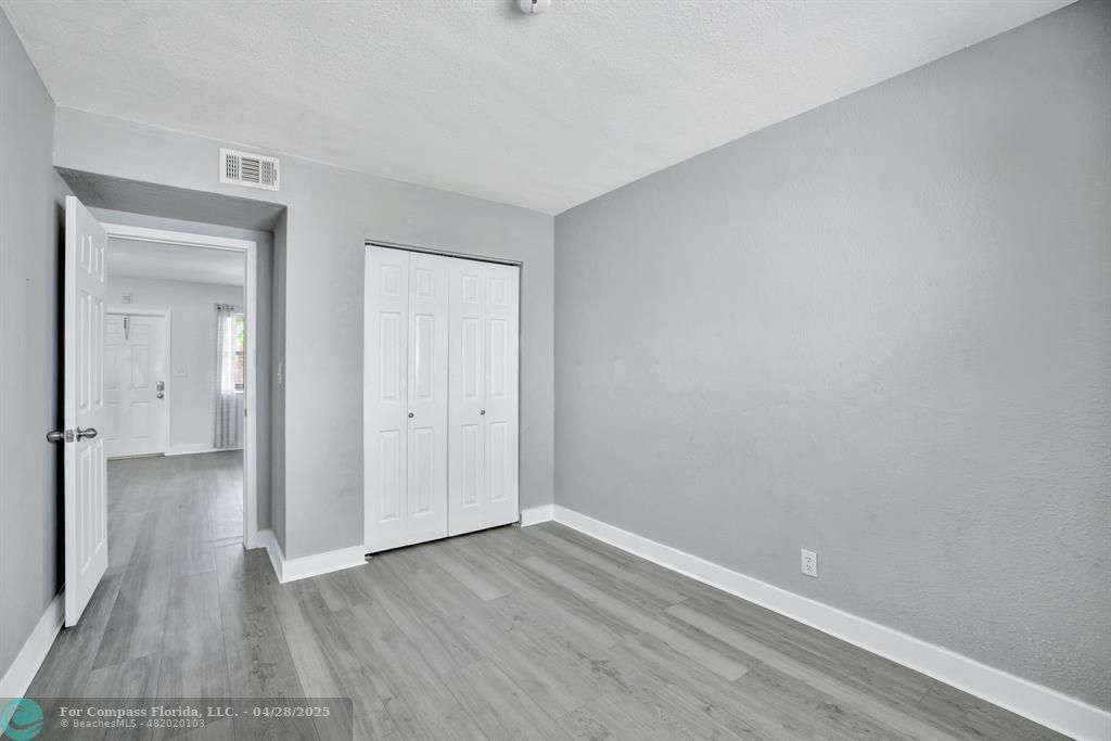 2741 Northeast 8th Avenue, Unit 15 Wilton Manors, FL 33334 - Photo 13 of 46 a view of an empty room with wooden floor