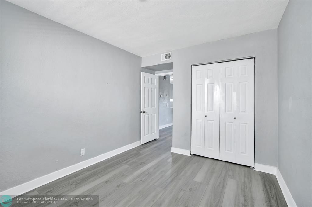 2741 Northeast 8th Avenue, Unit 15 Wilton Manors, FL 33334 - Photo 15 of 46 a view of an empty room and wooden floor